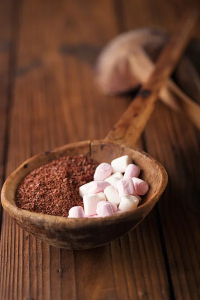 Grated chocolate and marshmallow candies in old spoon — Stock Photo, Image