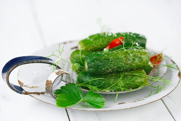 Freshly-salted cucumbers on vintage enamel sieve — Stock Photo, Image