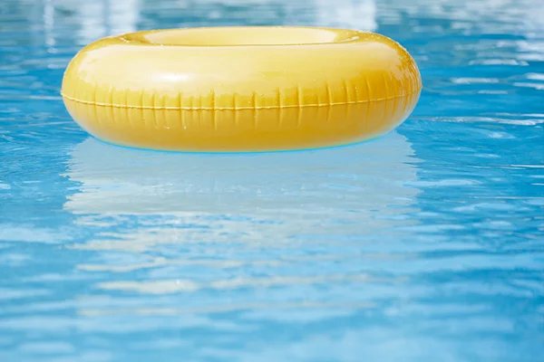 Floating ring on blue water swimpool — Stock Photo, Image