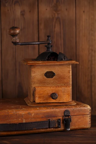 Nostalgic coffee grinder on old stool — Stock Photo, Image