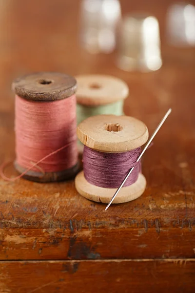 Real old reels spools treads with needle — Stock Photo, Image