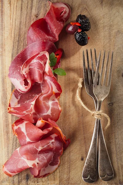 Cured Meat and vintage forks — Stock Photo, Image