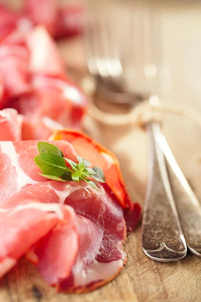 Cured Meat and vintage forks — Stock Photo, Image
