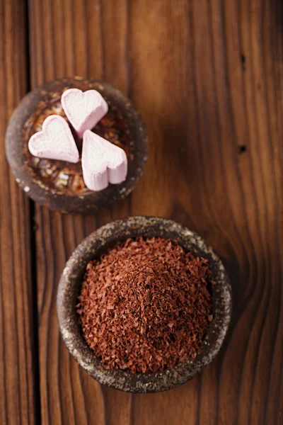 Fine grated chocolate and hearts — Stock Photo, Image