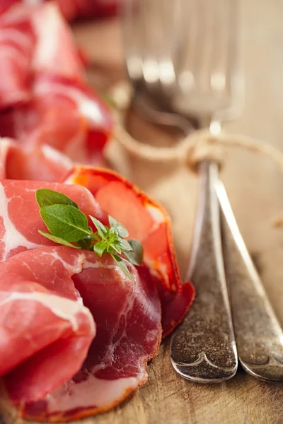 Cured Meat and vintage forks — Stock Photo, Image