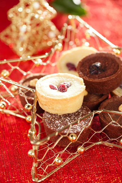 Chocolate tartlets in festive golden red — Stock Photo, Image