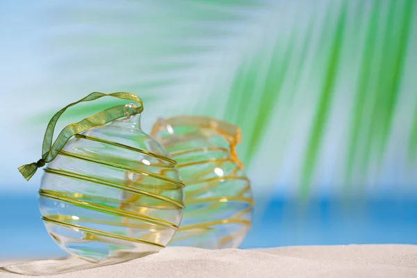 Glitter christmas glass balls on  beach — Stock Photo, Image