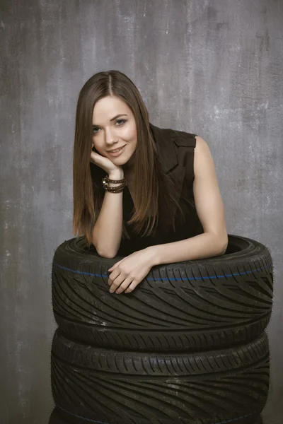 Portrait of a young girl who is inside automobile tires, on the — Stock Photo, Image