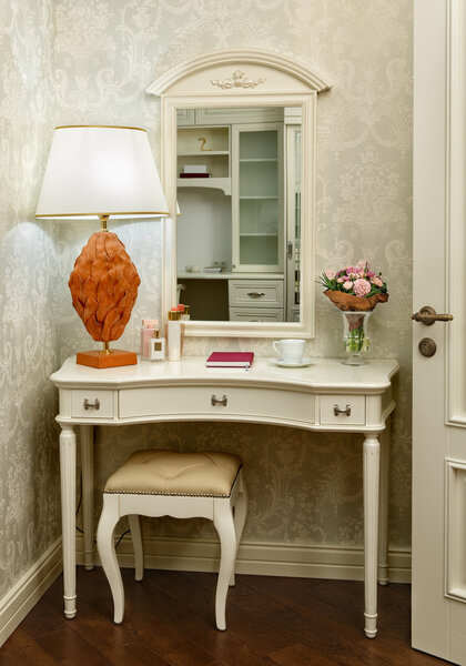 Interior of a bedroom in a classic style, with a dressing table,