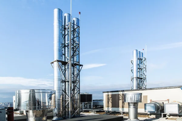 Industrial boiler flues, against the blue sky — Stock Photo, Image