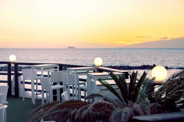 Empty bar at sunset on Tenerife island, Costa Adeje with sunset ocean view