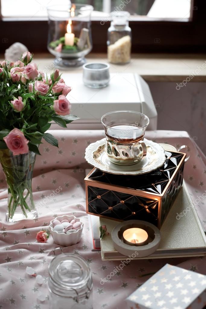 Romantic tea time settings with candles and roses