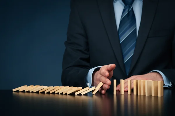 Businessman stop domino effect — Stock Photo, Image