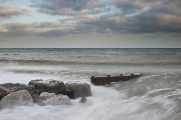 Beautiful long exposure sunset landscape image of pier at sea in — Stock Photo, Image