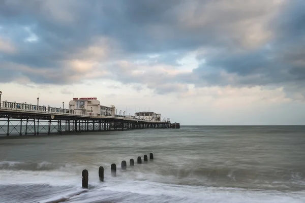 Beautiful long exposure sunset landscape image of pier at sea in — Stock Photo, Image