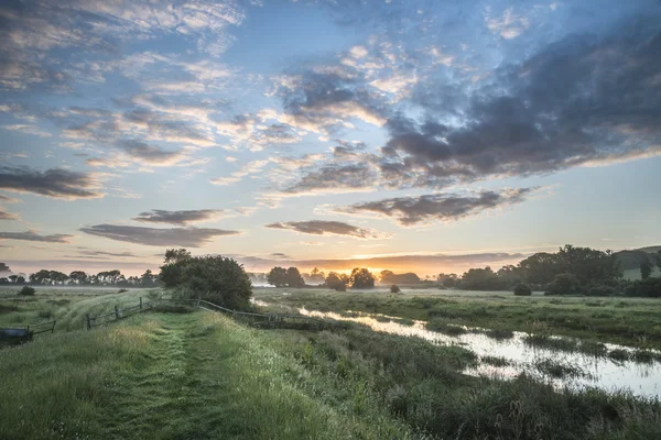 Piękne. żywe lato wschód słońca nad angielskiej wsi scenerii. — Zdjęcie stockowe