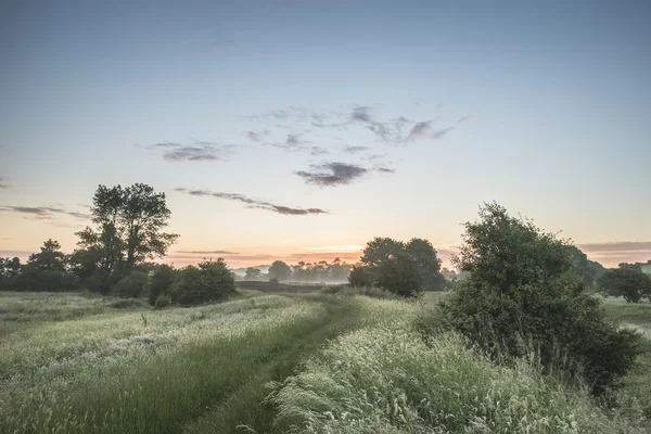 Beautiful vibrant Summer sunrise over English countryside landsc — Stock Photo, Image