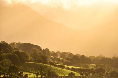 Low 'un yanında gün doğumunun göz kamaştırıcı altın ışığı yaz sonlarında İngiliz Lake District kırsalında düştü.