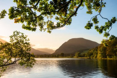 Lovely sunrise landscape image looking along Loweswater towards wonderful light on Grasmoor and Mellbreak mountains in Lkae District clipart