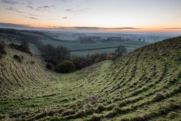 Stunning sunrise over fog layers in countryside landscape — Stock Photo, Image