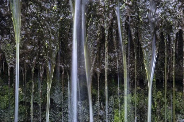 Image détaillée du paysage de cascade coulant sur des rochers herbeux — Photo