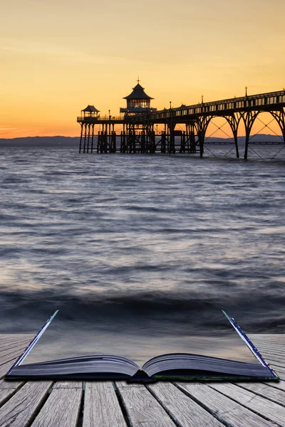 Beautiful long exposure sunset over ocean with pier silhouette c