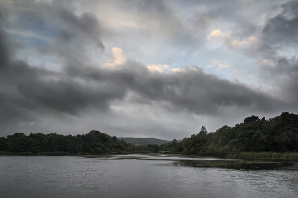 Autumn Fall landscape image stormy dramatic sky over calm lake — Stock Photo, Image