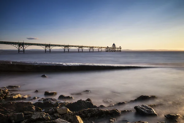 Long exposure landscape image of pier at sunset in Summer — Stock Photo, Image