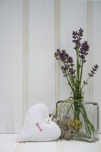 Beautiful flower in vase with heart still life love concept — Stock Photo, Image