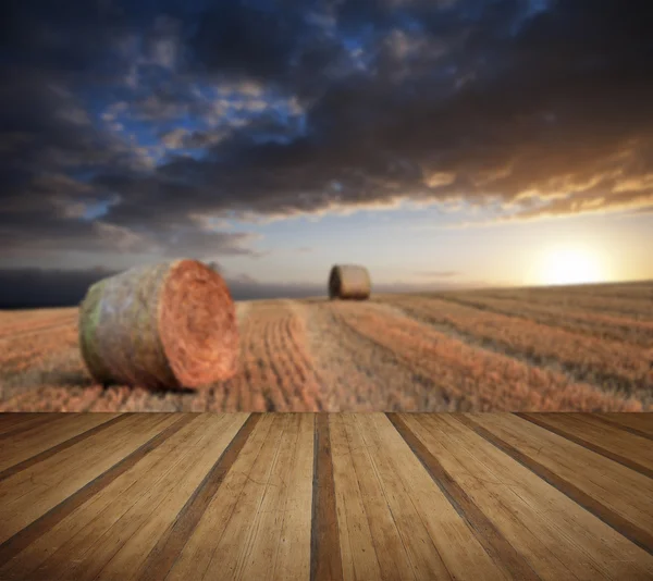 Beautiful golden hour hay bales sunset landscape with wooden pla — Stock Photo, Image