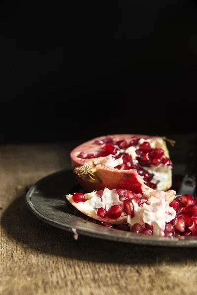 Moody natrual lighting images of fresh juicy pomegranate with vi