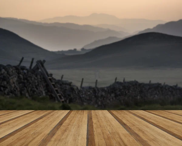 View along misty valley towards Snowdonia mountains with wooden — Stock Photo, Image