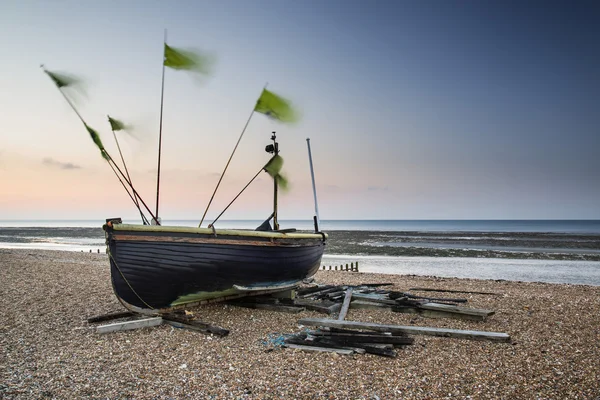 Landscape image of small fishing boats on beach at sunrise in Sp — Stock Photo, Image