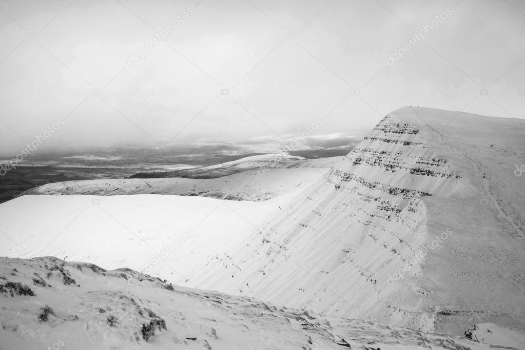 Stunning landscape of snow covered mountains in Winter in black 