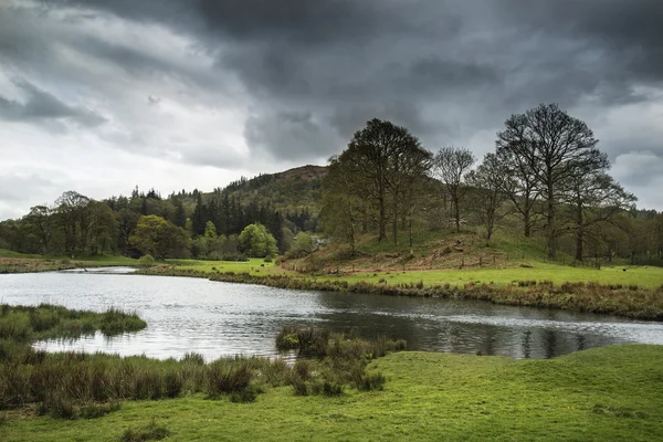 Stormy dramatic sky over Lake District countryside landscape — Stock Photo, Image