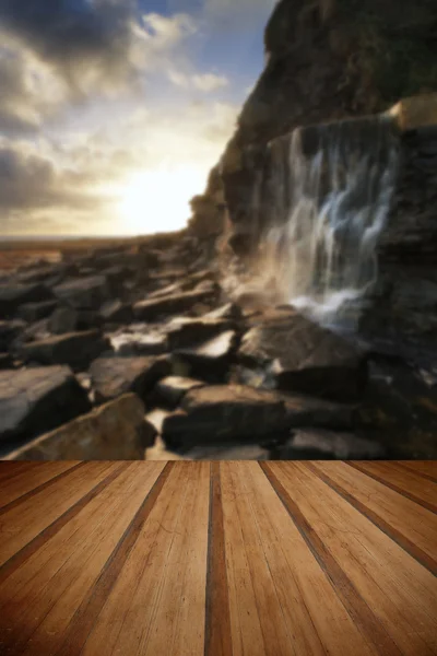 Beautiful landscape image waterfall flowing into rocks on beach — Stock Photo, Image