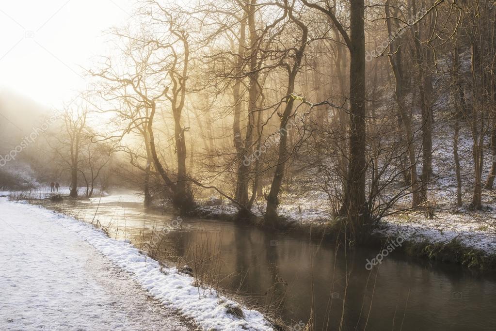 Beautiful Winter snow covered countryside landscape of river flo