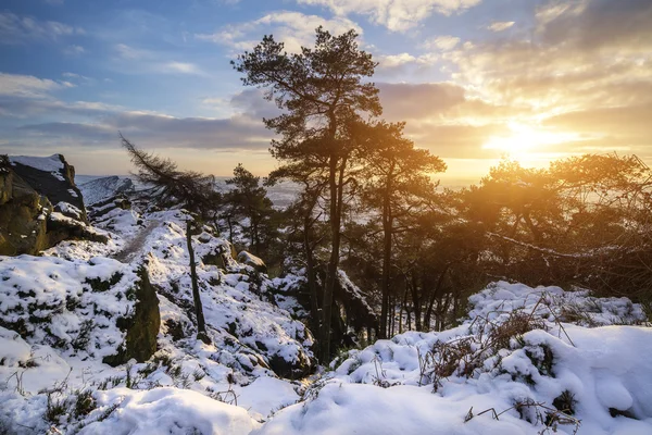 Stunning Winter sunset landscape from mountains looking over sno — Stock Photo, Image