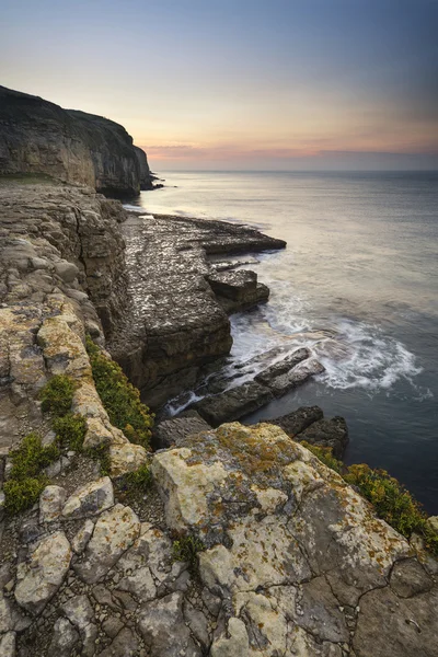 Stunning coastal landscape with long exposure waves crashing at — Stock Photo, Image