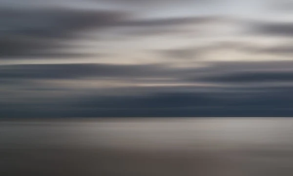 Imagen conceptual del paisaje del desenfoque del movimiento en el océano durante su — Foto de Stock