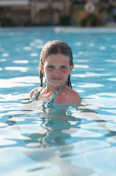 Ten years girl in pool Royalty Free Stock Images