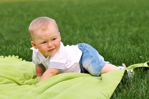 Little boy on green blanket — Stock Photo, Image