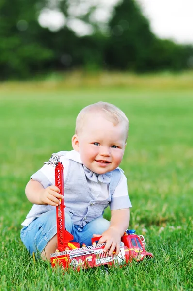 Child boy with red car — Stock Photo, Image