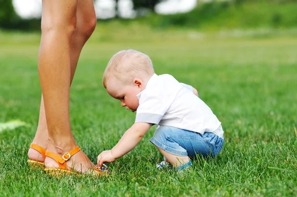 Little child touch mom's shoes — Stock Photo, Image