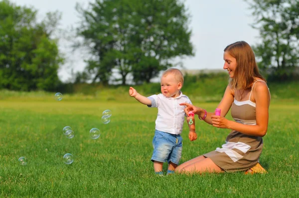 Boy with mom and air bubbles — Stock Photo, Image