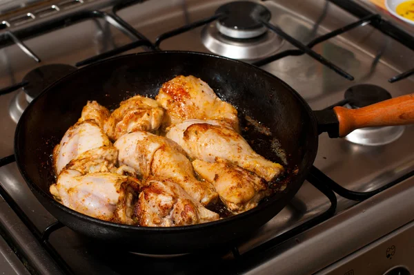 Frying pan with chicken legs inside — Stock Photo, Image