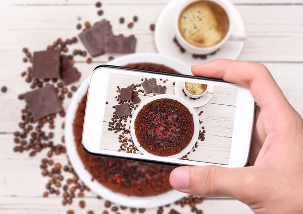 Hands taking photo truffle chocolate cake with smartphone. — Stock Photo, Image