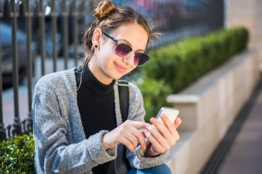 Cep telefonu açık havada kullanan kız.