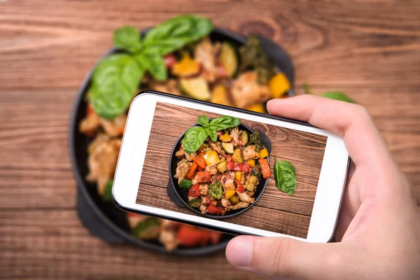 Las manos tomando fotos mexicanas de pollo salteado con teléfono inteligente . —  Fotos de Stock