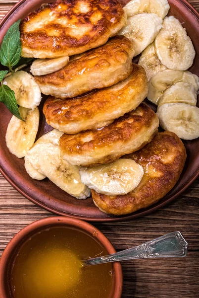 Pancakes with fresh banana and honey for breakfast, top view. — Stock Photo, Image